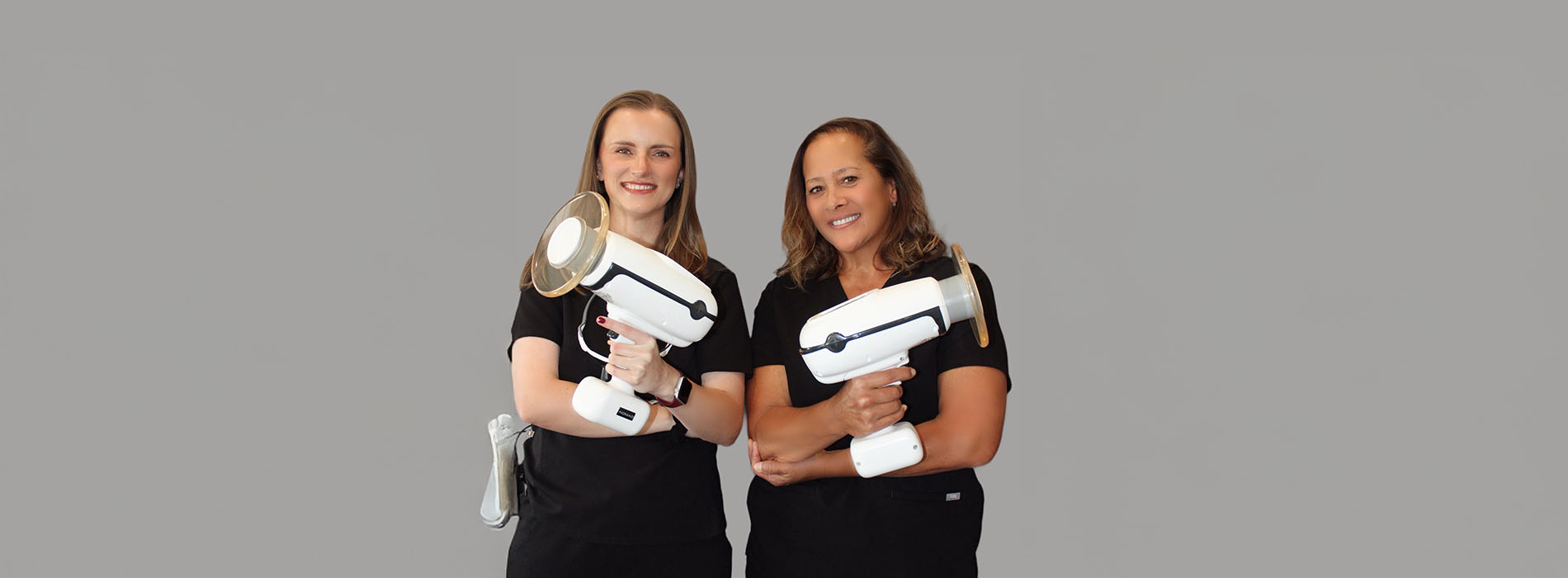 A well-lit reception area with a desk, computer monitor, and potted plant.