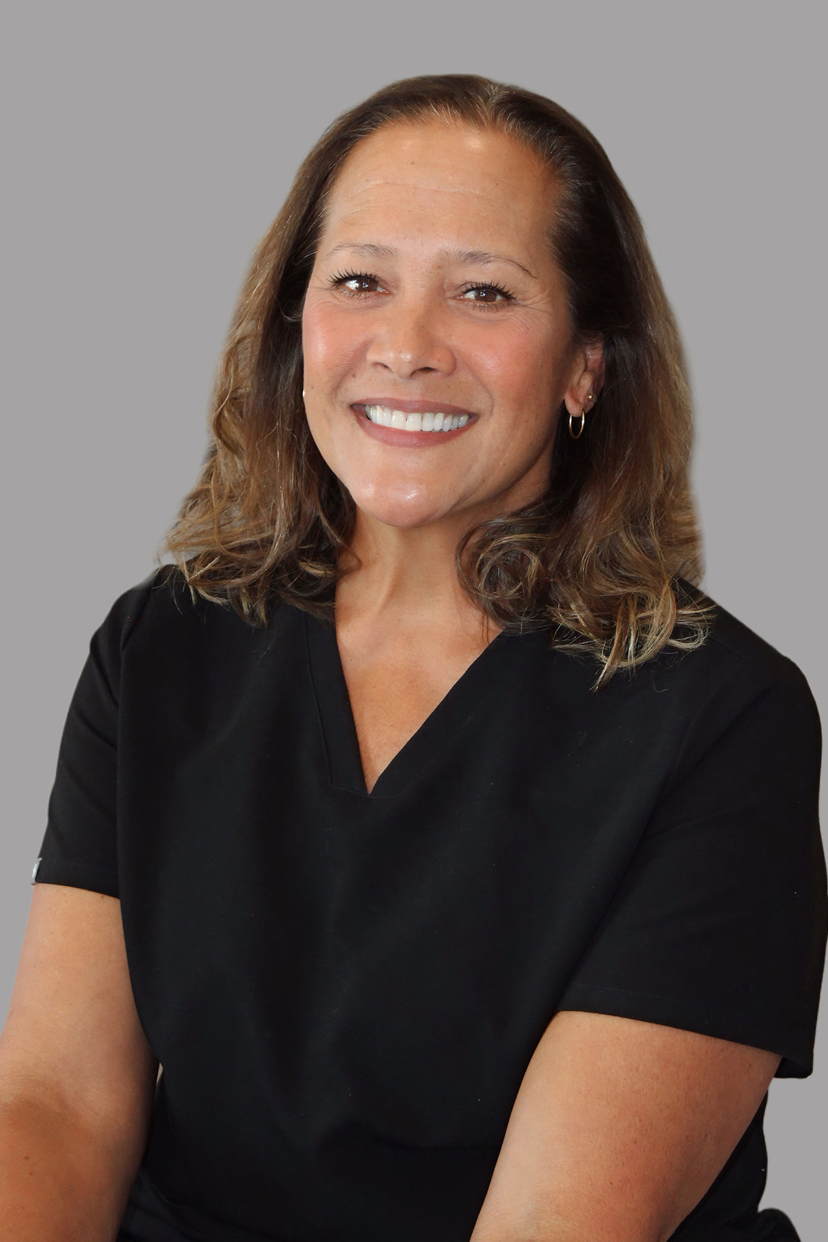 Woman wearing a black shirt and smiling at the camera.